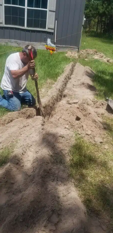 Digging a ditch by hand for a new underground powerline in Comfort, TX